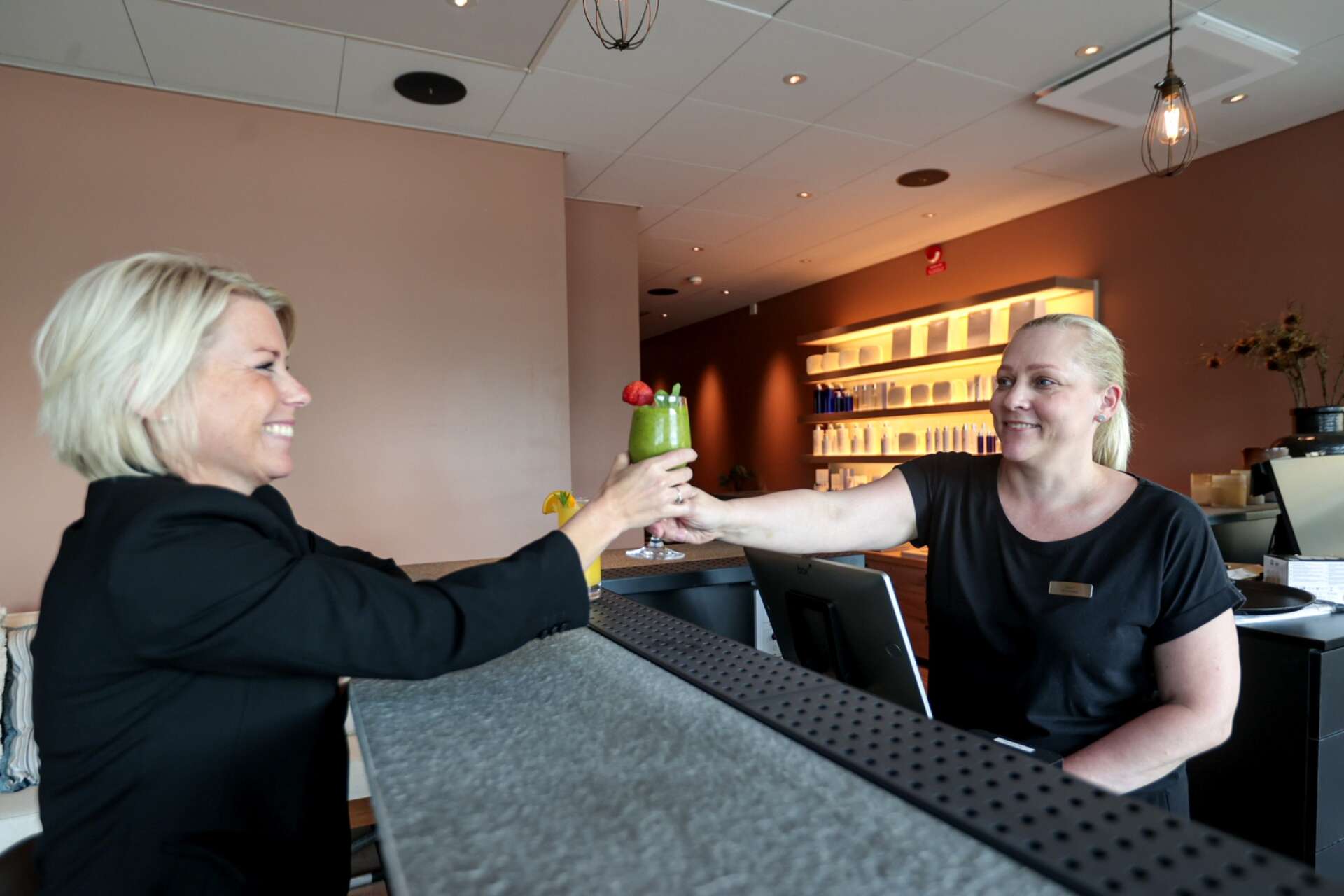 Anna Björkenstam Wedberg serveras en drink av Jenny Heed som är spaansvarig.