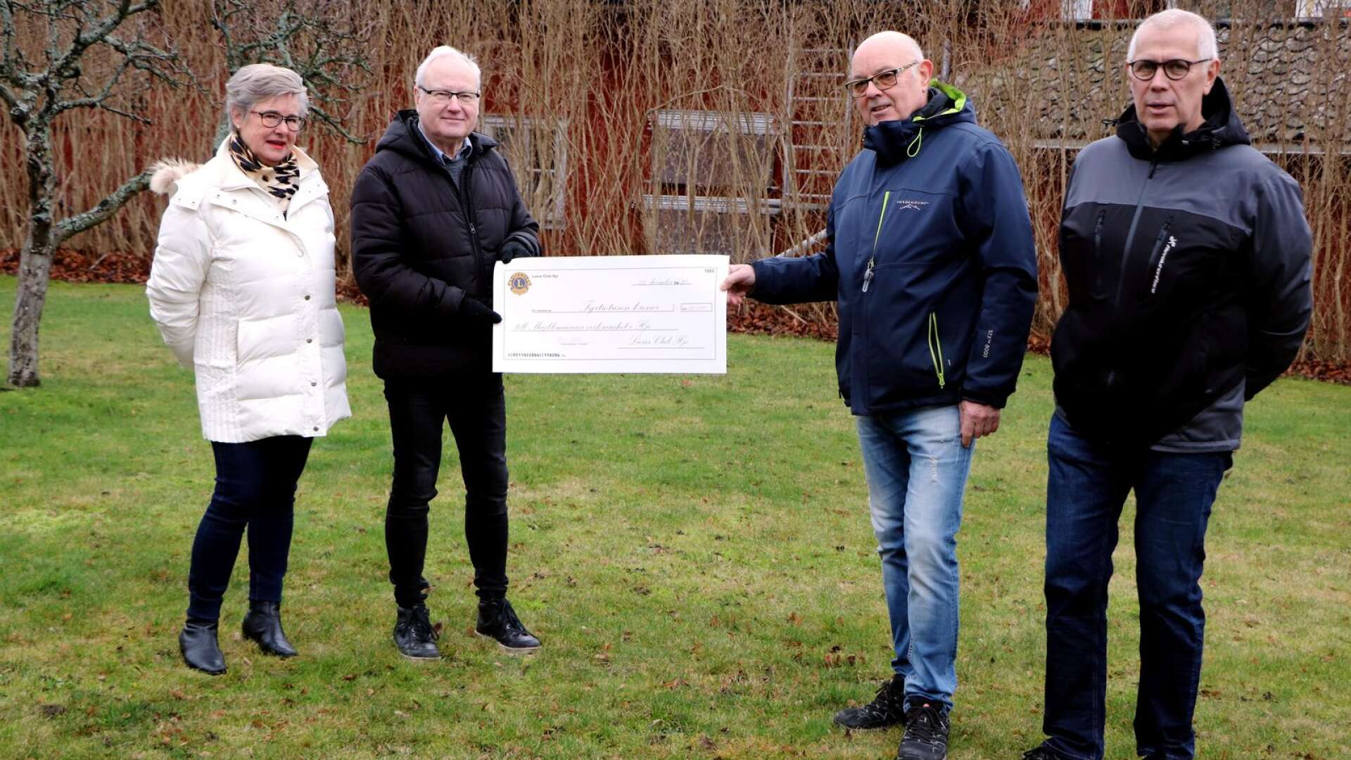 Majblommans Lena Englund och Rutger Gram tar emot checken på 40 000 kronor av Lions Richard Bankler och Stefan Wallenå.