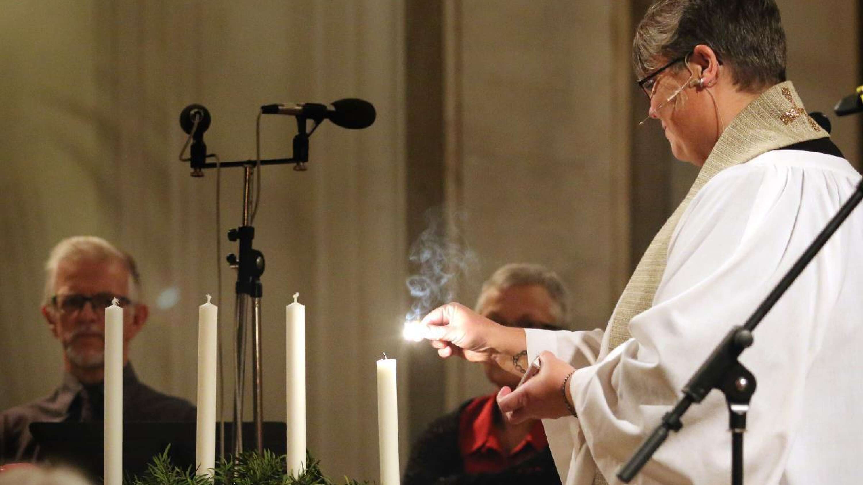 Prästen Ellinor Carlberg Mehrén tände två ljus, ett för första advent och ett för barn som far illa.