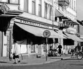 I Viktorinska huset – tidigare kallat AK-huset – låg A Karlsson &amp; Co, som blev Säffles första snabbköp. Manufaktur på hörnet och livsmedelsbutik som granne till Holgers konditori. Till höger i bild skymtar huset där Handelscentrum hade sin affär. Det brann en marknadsdag i början av 1960-talet.