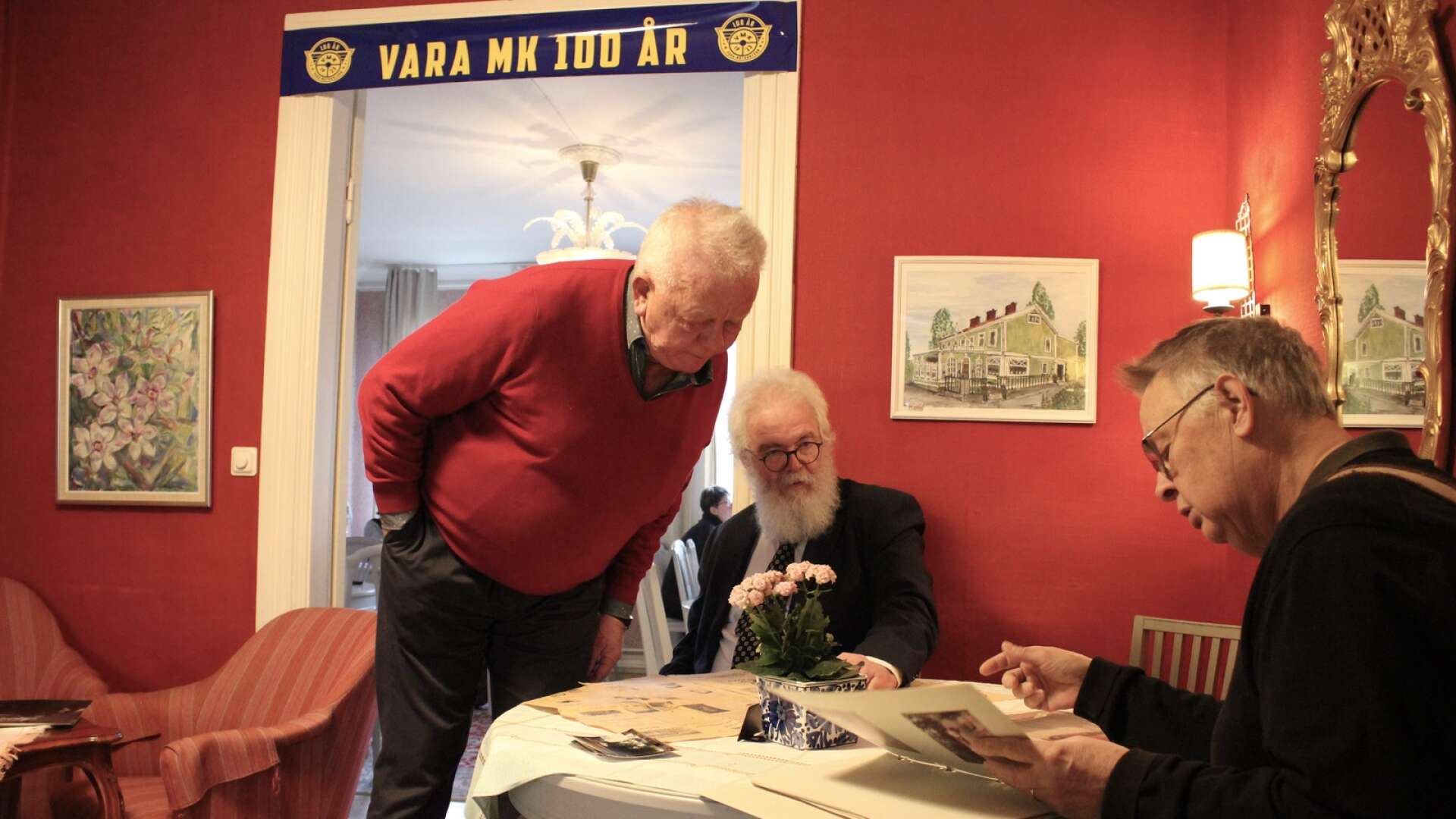 Leif &quot;Fjärdingen&quot; Andersson, Vara MK:s sekreterare Jonas Öhman och tidigare ordförande Bengt Johansson tittar på gamla foton och tidningsartiklar.