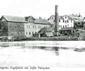 Berggren &amp; Bengzon etablerade sig i Säffle 1901. Något år senare lät man trycka ett vykort på eget förlag, av allt att döma i reklamsyfte. Orgelfabriken var inrymd i trähuset bakom den höga skorstenen. 