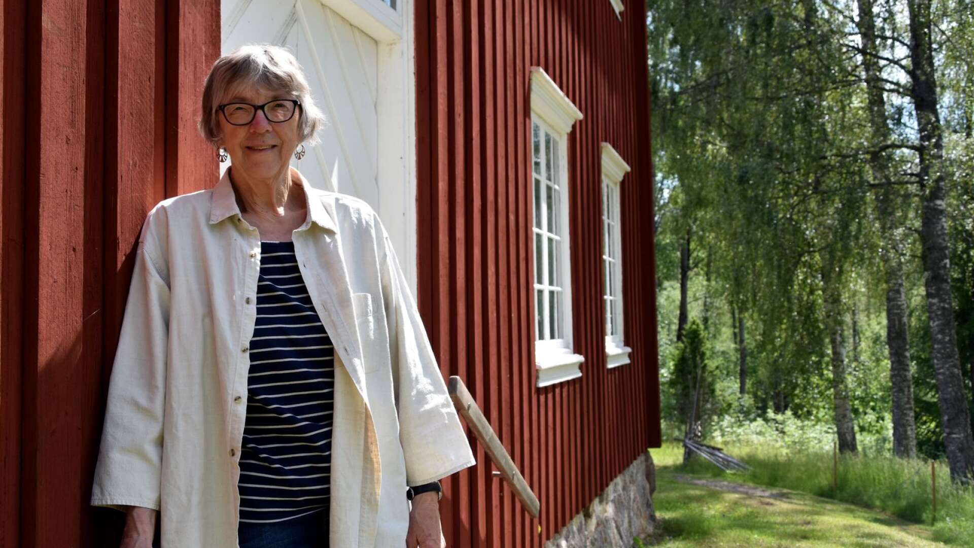 Anna-Märta Larsson, ordförande i Gunnarskogs hembygdsförening, berättar om midsommarfirandet.