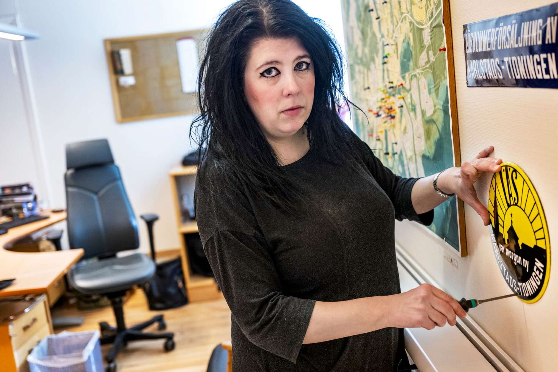 Karlstads-Tidningens chefredaktör Veronica Sjöblom tar ner skylten på kontoret. 