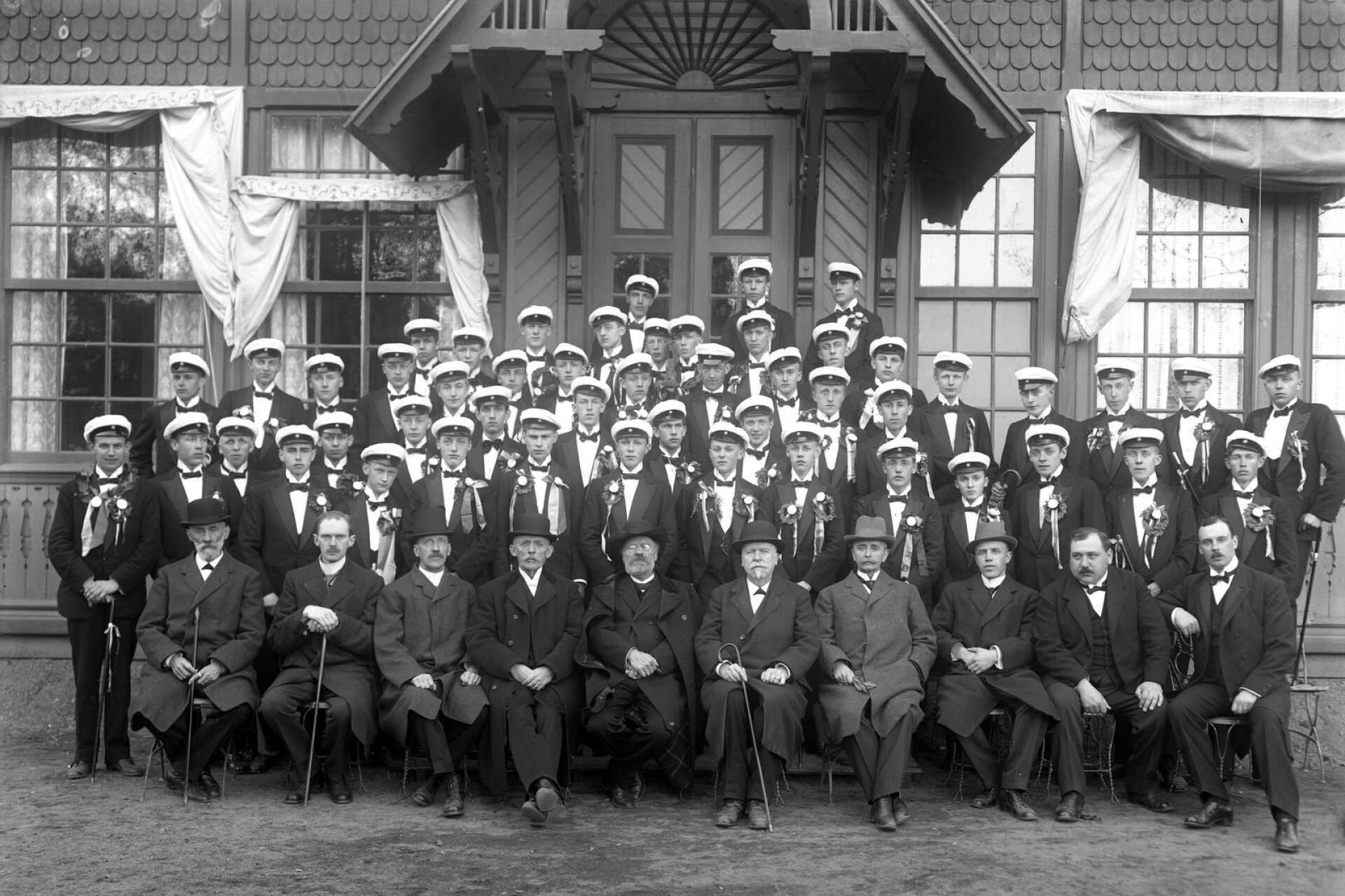 Nyblivna studenter grupperade framför restaurangen i Stadsträdgården med sina lärare under 1920-talet första hälft